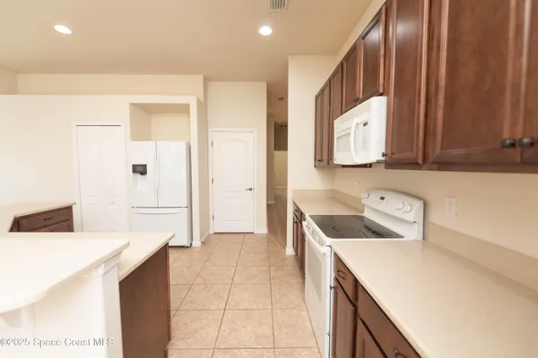 a kitchen with a sink a stove top oven and cabinets