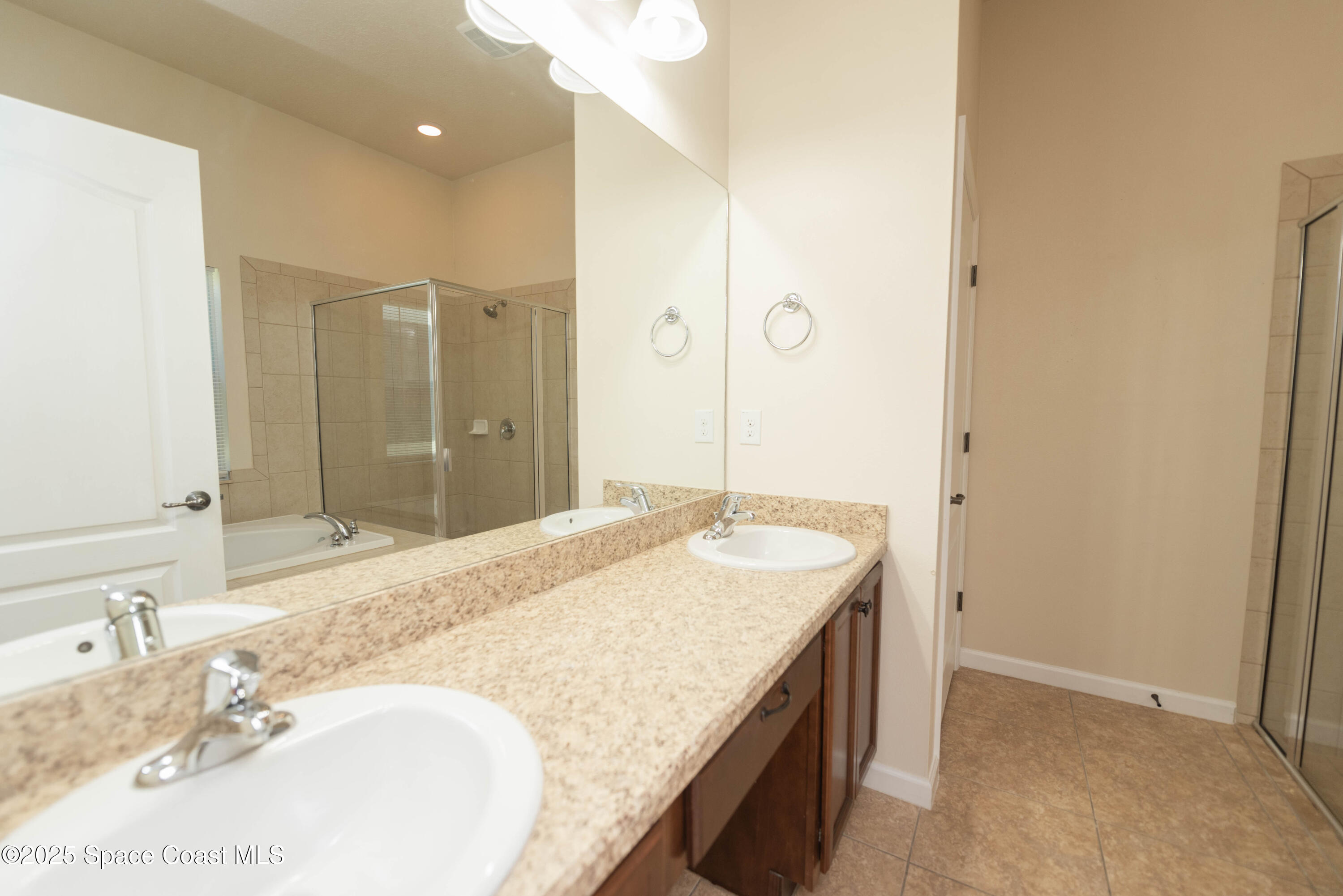 3136 Constellation Drive Melbourne, FL 32940 - Photo 9 of 28 a bathroom with a granite countertop sink and a mirror