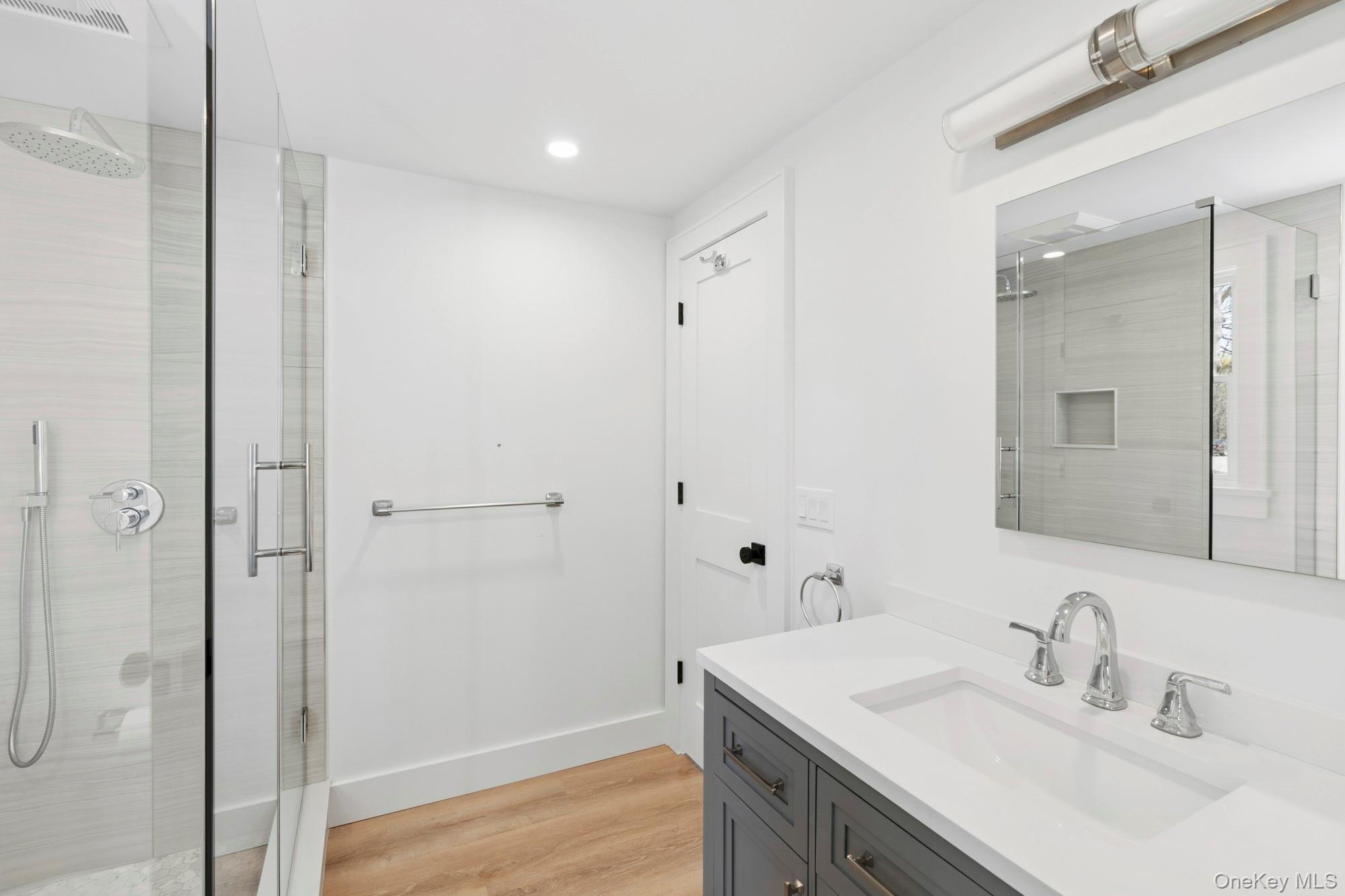 5075 Main Road Laurel, NY 11948 - Photo 12 of 22 a bathroom with a sink and a mirror