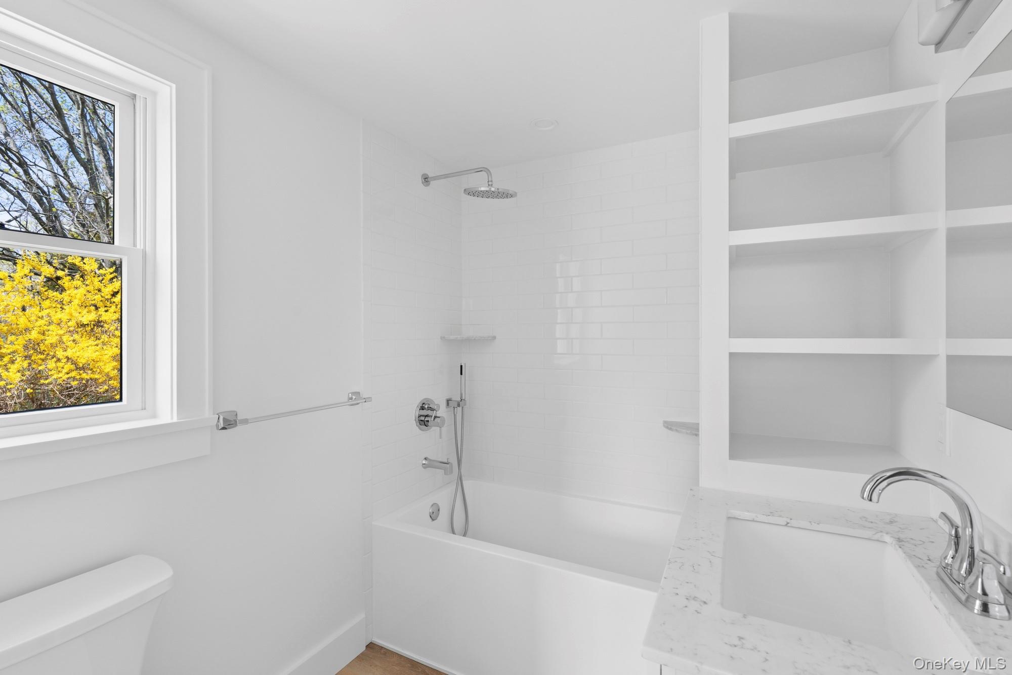 5075 Main Road Laurel, NY 11948 - Photo 15 of 22 a bathroom with a tub sink and vanity