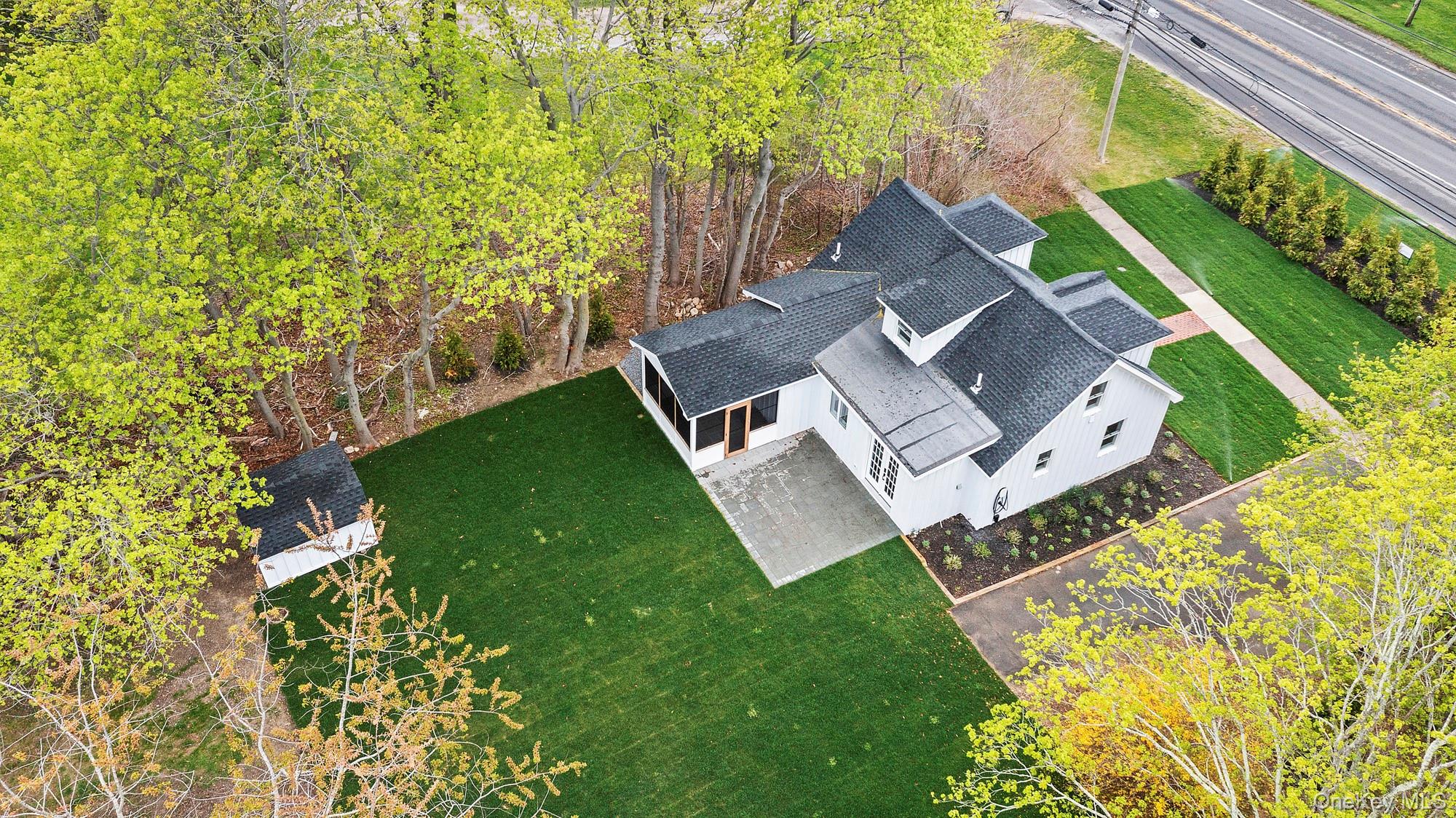 5075 Main Road Laurel, NY 11948 - Photo 2 of 22 an aerial view of a house with garden