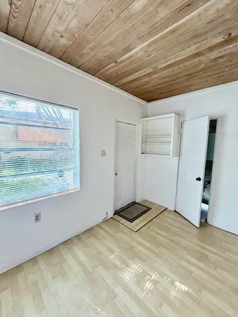 a view of a room with wooden floor