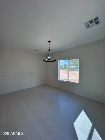 a view of a livingroom with a ceiling fan and window