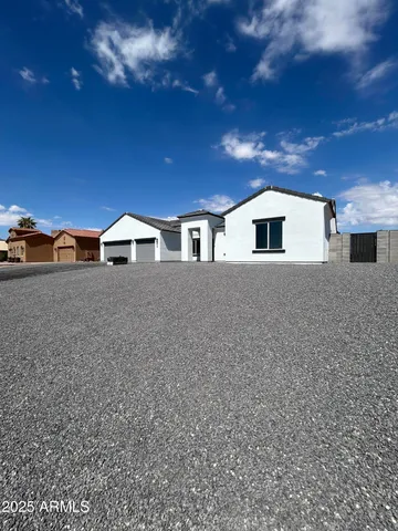 a large kitchen with stainless steel appliances a large counter top a stove and a refrigerator