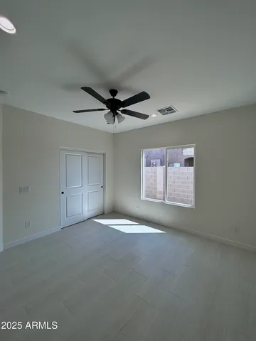 a view of room with a ceiling fan