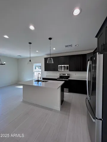 a kitchen with wooden cabinets and stainless steel appliances