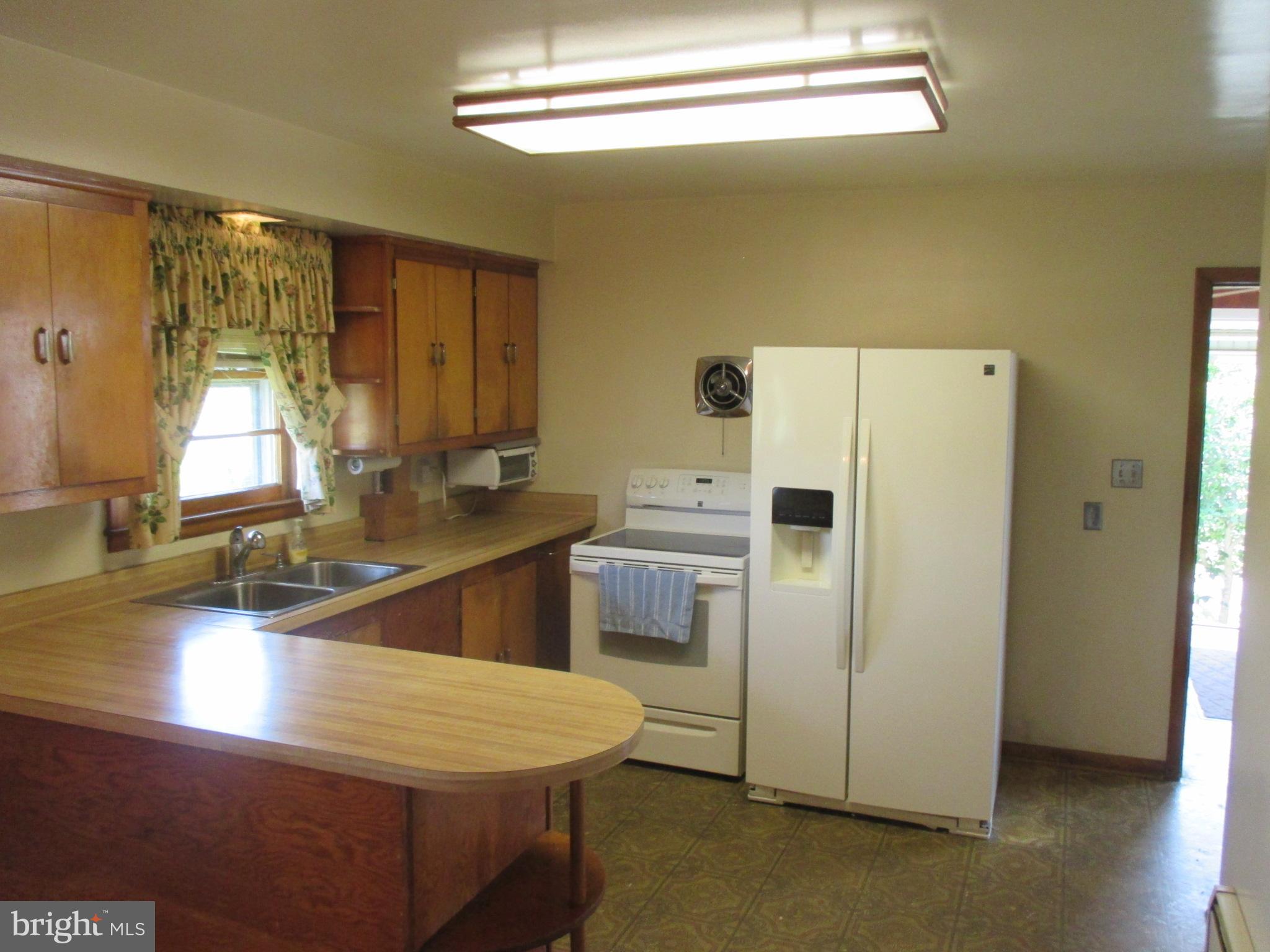 230 West Bay Front Road Lothian, MD 20711 - Photo 18 of 30 a kitchen with a refrigerator a stove a sink and a window