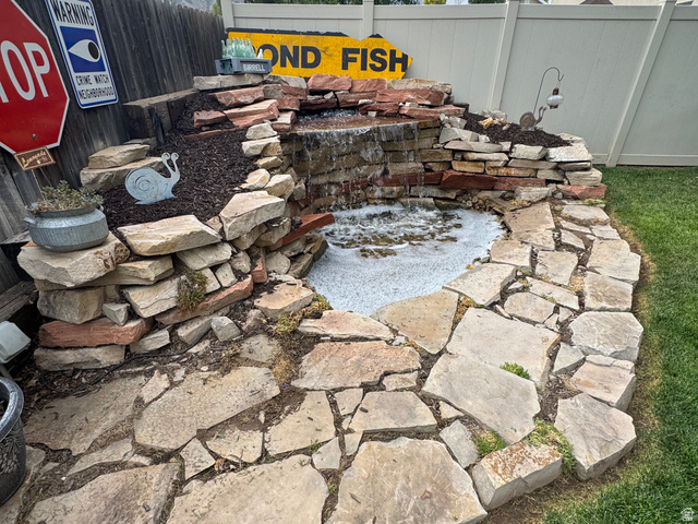 1237 South 260 West Payson, UT 84651 - Photo 14 of 81 Stone water feature with a waterfall, flagstone patio, and a wood privacy fence