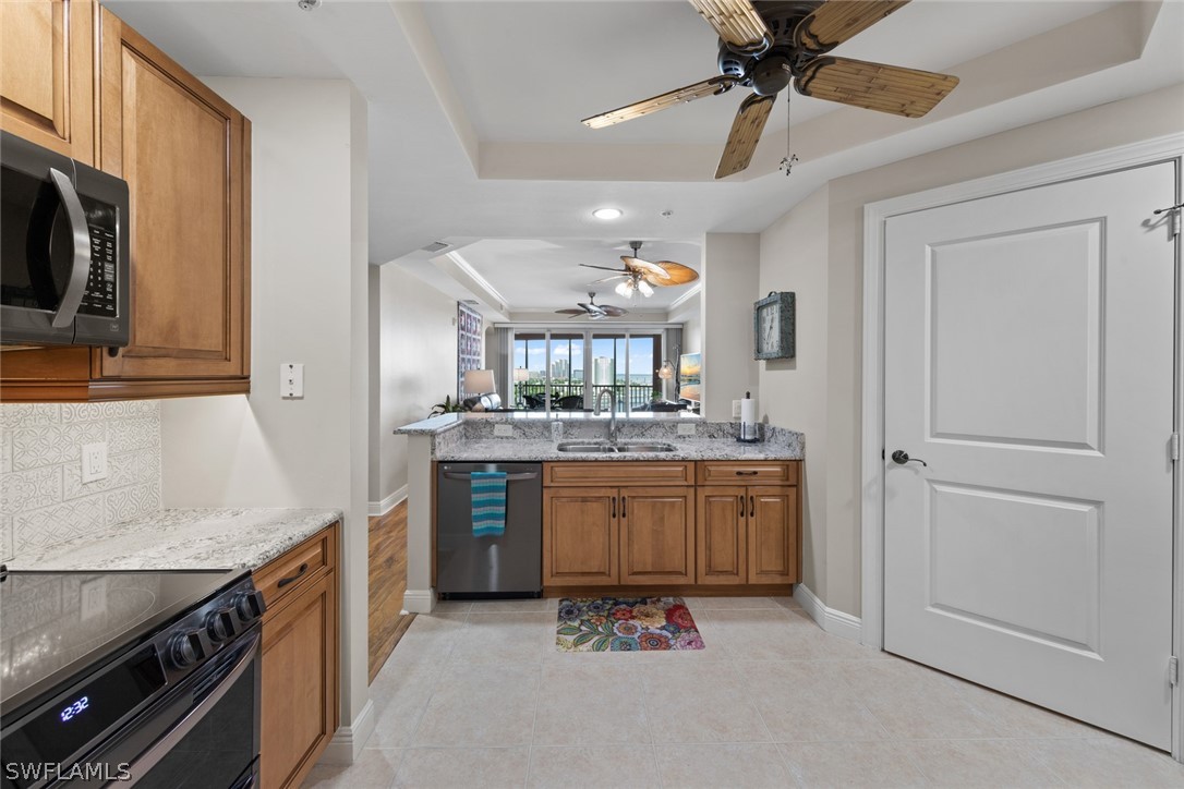 2743 First Street, Unit 1101 Fort Myers, FL 33916 - Photo 11 of 49 a large kitchen with stainless steel appliances granite countertop a stove a sink and a refrigerator