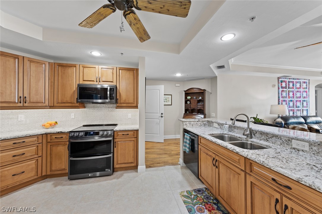 2743 First Street, Unit 1101 Fort Myers, FL 33916 - Photo 12 of 49 a kitchen with stainless steel appliances granite countertop a sink and a stove