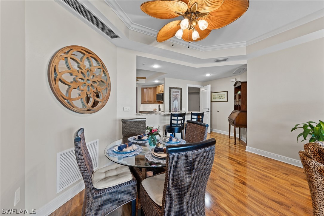 2743 First Street, Unit 1101 Fort Myers, FL 33916 - Photo 14 of 49 a dining room with furniture and wooden floor