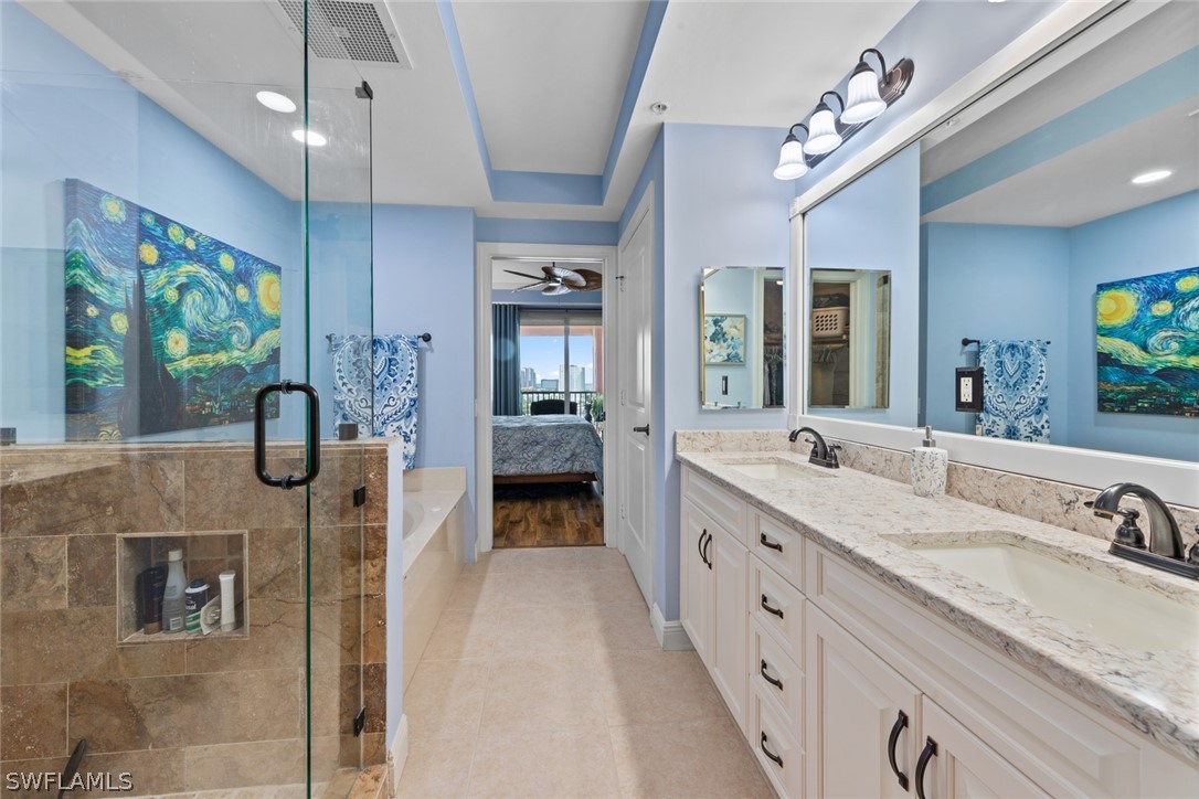 2743 First Street, Unit 1101 Fort Myers, FL 33916 - Photo 23 of 49 a spacious en suite bathroom with a granite countertop sink mirror and shower