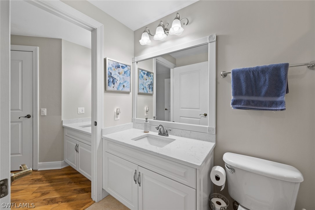 2743 First Street, Unit 1101 Fort Myers, FL 33916 - Photo 28 of 49 a bathroom with a toilet sink and mirror