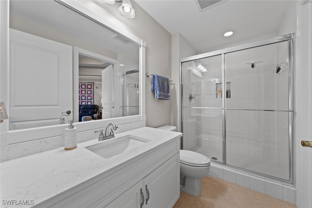 2743 First Street, Unit 1101 Fort Myers, FL 33916 - Photo 29 of 49 a bathroom with a sink toilet a mirror and shower