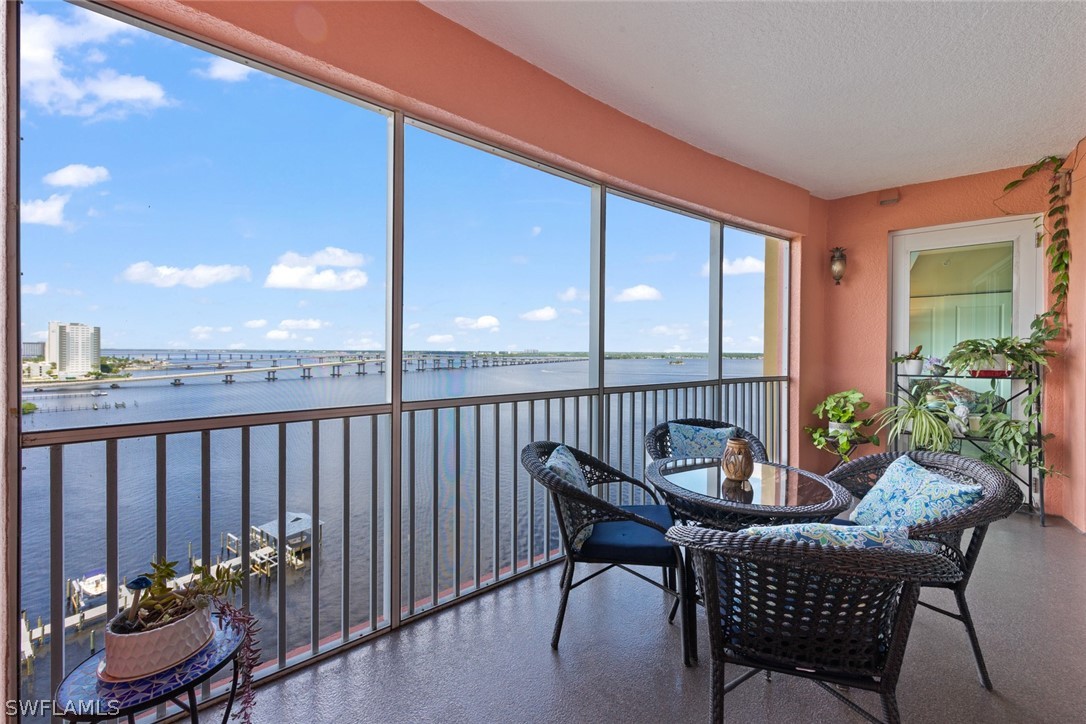 2743 First Street, Unit 1101 Fort Myers, FL 33916 - Photo 5 of 49 a view of a chair and tables in the balcony