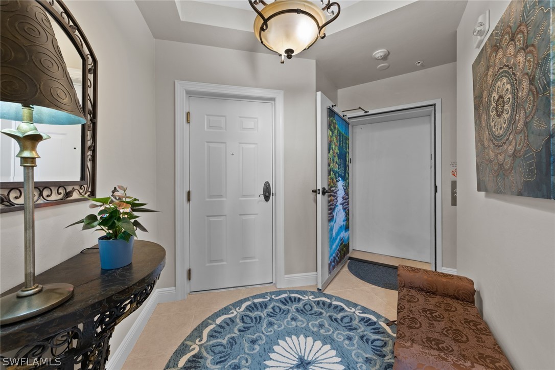 2743 First Street, Unit 1101 Fort Myers, FL 33916 - Photo 6 of 49 a bedroom with a bed and a chandelier