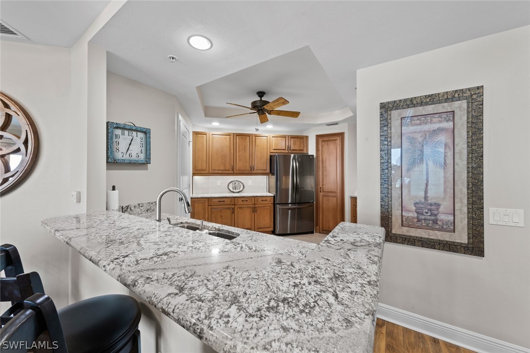 2743 First Street, Unit 1101 Fort Myers, FL 33916 - Photo 8 of 49 a kitchen with granite countertop a stove a sink and a refrigerator