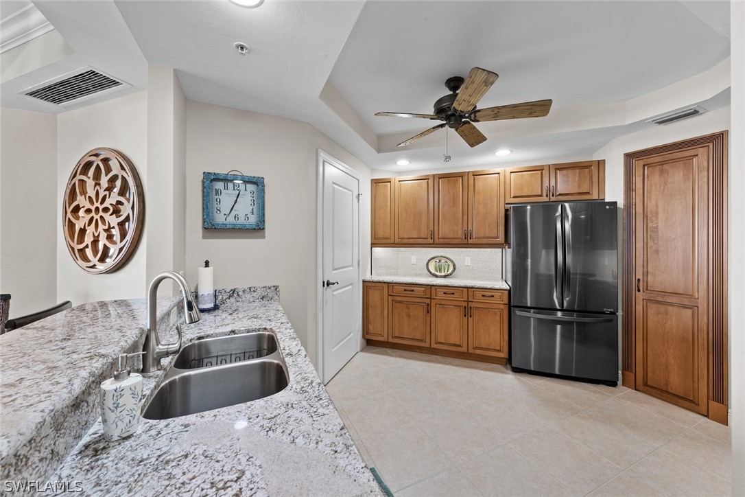 2743 First Street, Unit 1101 Fort Myers, FL 33916 - Photo 9 of 49 a kitchen with stainless steel appliances granite countertop a refrigerator and a sink