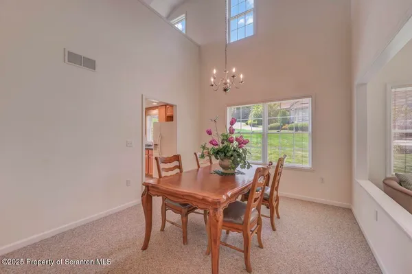 a living room with furniture chandelier and a chandelier