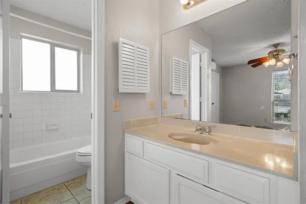a bathroom with a sink tub double vanity and a mirror