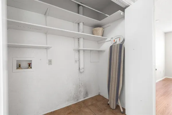 a view of walk in closet with empty racks