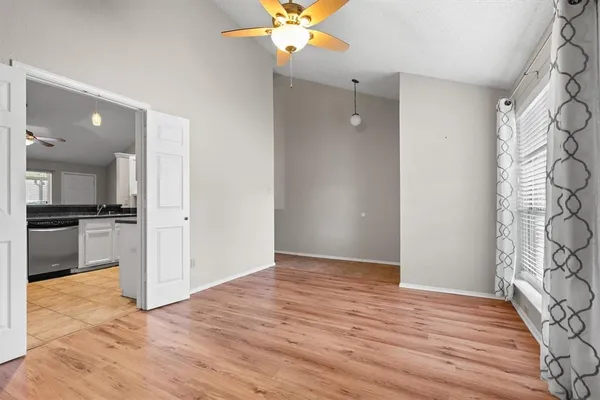 a view of a kitchen with a sink and a refrigerator