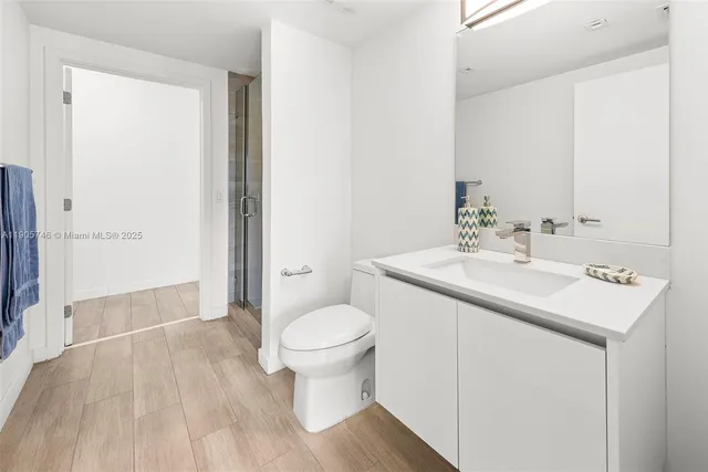 a bathroom with a sink toilet and shower