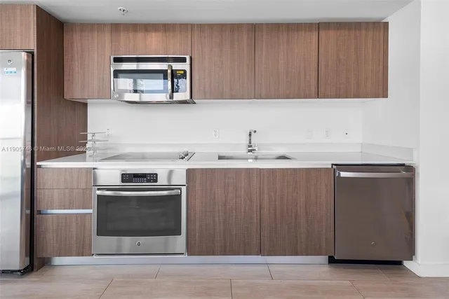 a kitchen with a stove microwave and sink