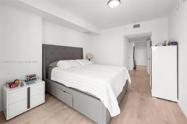 a large white bed in a white room