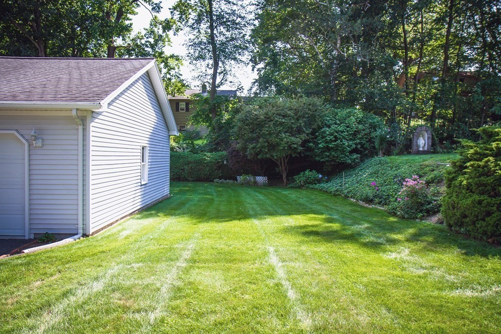 106 Lawrence Road Chicopee, MA 01013 - Photo 13 of 39 a view of a backyard with a garden