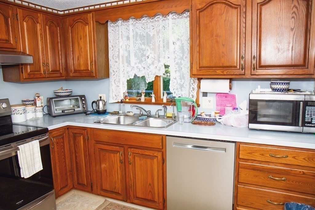 106 Lawrence Road Chicopee, MA 01013 - Photo 19 of 39 a kitchen with stainless steel appliances granite countertop a sink and cabinets