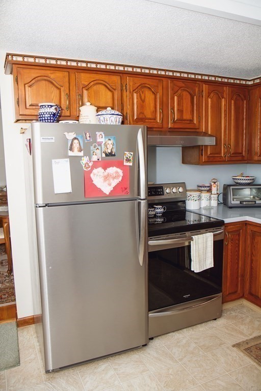 106 Lawrence Road Chicopee, MA 01013 - Photo 20 of 39 a kitchen with stainless steel appliances granite countertop a refrigerator and a stove