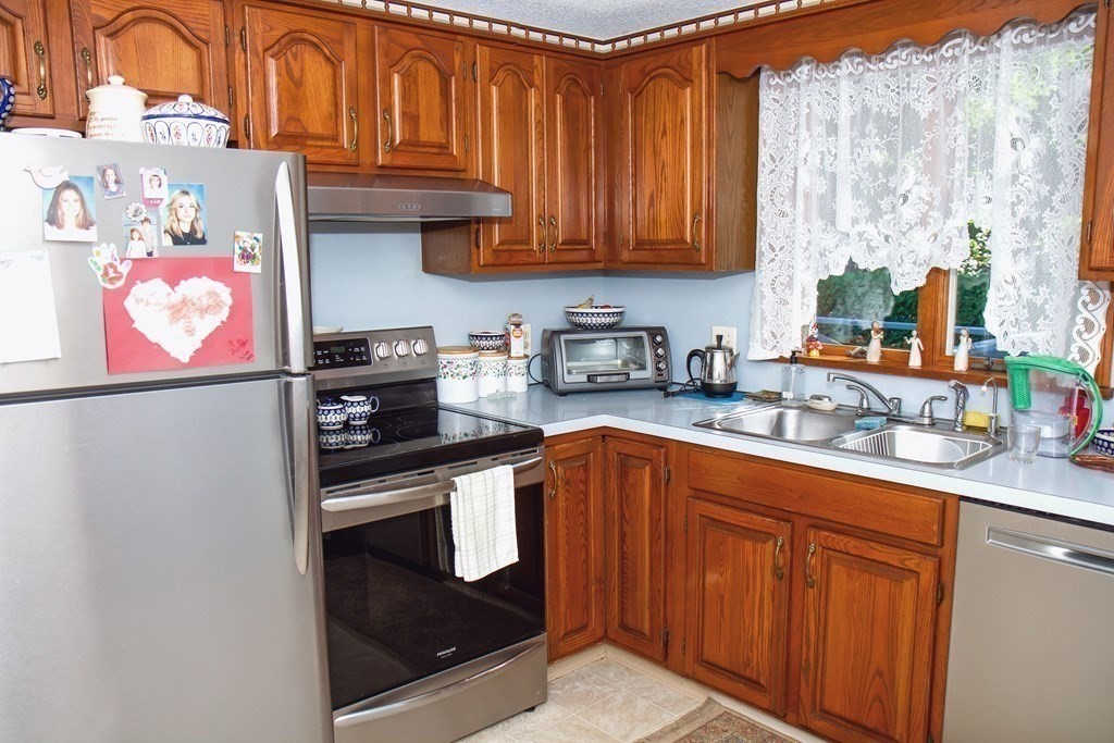 106 Lawrence Road Chicopee, MA 01013 - Photo 21 of 39 a kitchen with stainless steel appliances granite countertop a sink stove and cabinets