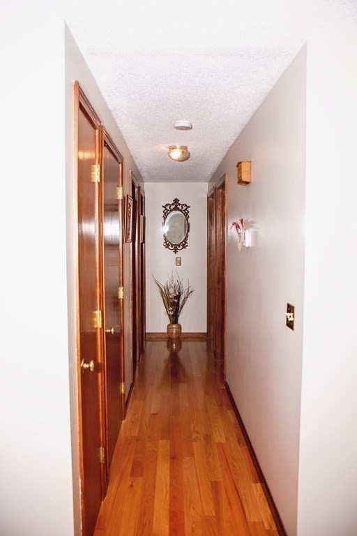 106 Lawrence Road Chicopee, MA 01013 - Photo 23 of 39 a view of a hallway with wooden floor and a bathroom