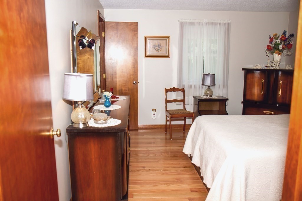 106 Lawrence Road Chicopee, MA 01013 - Photo 29 of 39 a bedroom with a bed and a chandelier