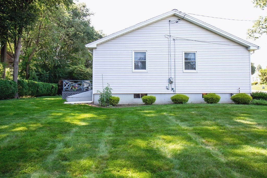 106 Lawrence Road Chicopee, MA 01013 - Photo 5 of 39 a view of a house with a yard and a garden
