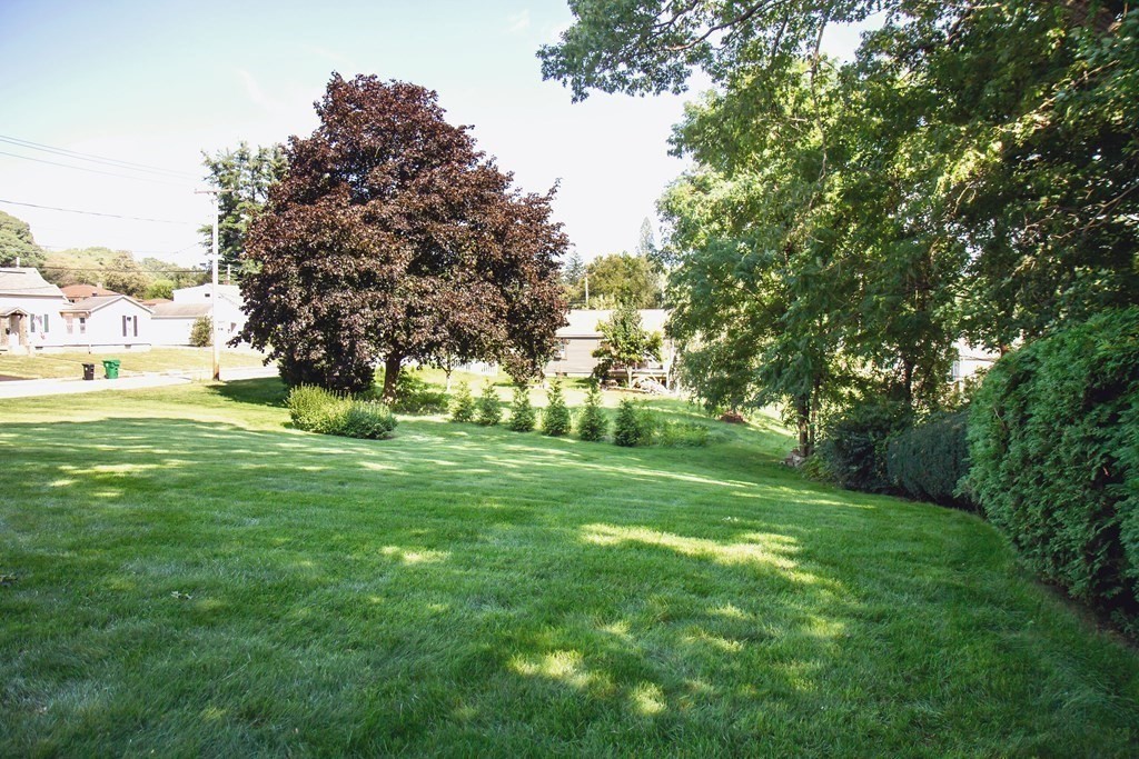 106 Lawrence Road Chicopee, MA 01013 - Photo 6 of 39 a view of grassy field with benches and trees all around