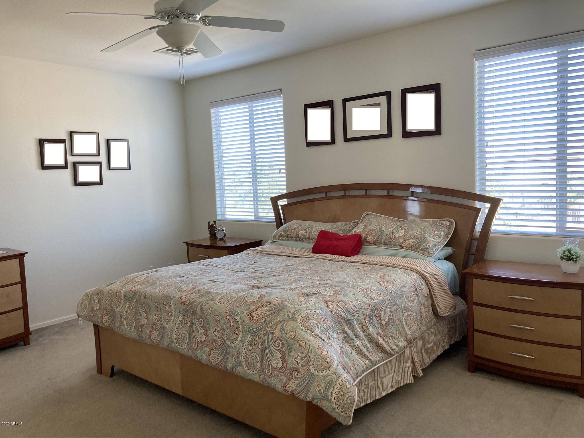 7342 West Carter Road Laveen, AZ 85339 - Photo 12 of 18 a bedroom with a bed and a ceiling fan