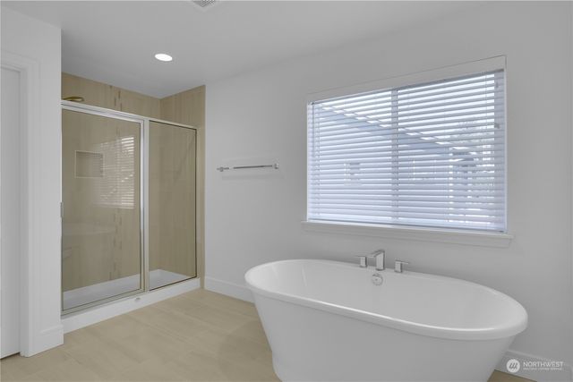 a bathroom with a bathtub and a shower