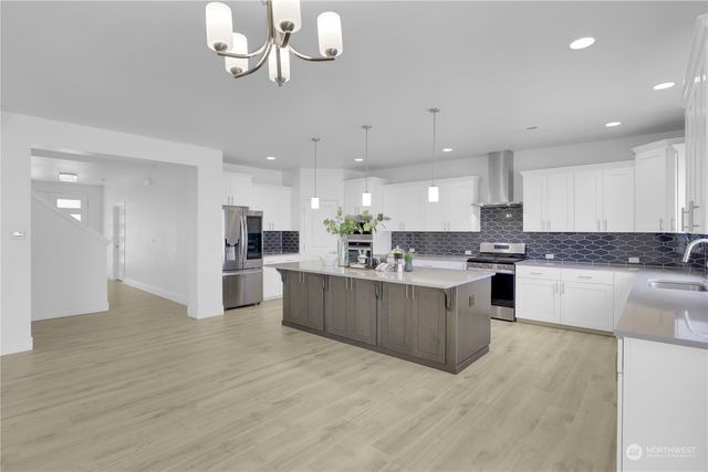 a large kitchen with a large counter top appliances and cabinets