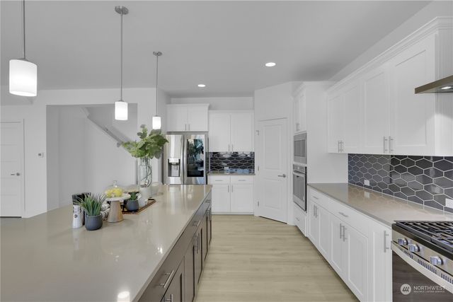 a kitchen with kitchen island granite countertop counter space a sink and appliances