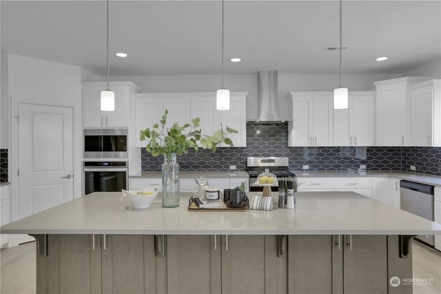 a kitchen with counter top space cabinets and stainless steel appliances