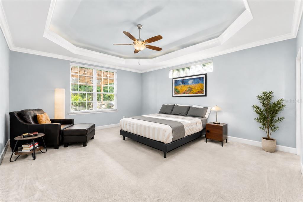 8942 Southwest 25 Road Gainesville, FL 32608 - Photo 9 of 22 a bedroom with a bed and a chandelier