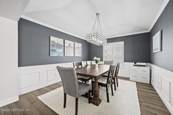 a view of a dining room with furniture window and wooden floor