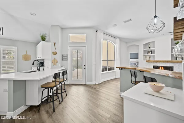 a view of kitchen island dining table wooden floor and kitchen view