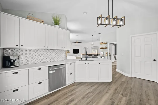 a kitchen with kitchen island white cabinets and white appliances