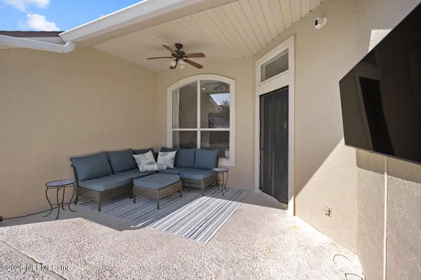 a view of a livingroom with furniture and a ceiling fan