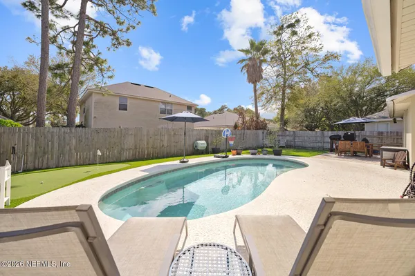 a view of a swimming pool with a patio