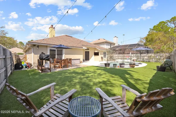 a view of a swimming pool and a chairs in patio