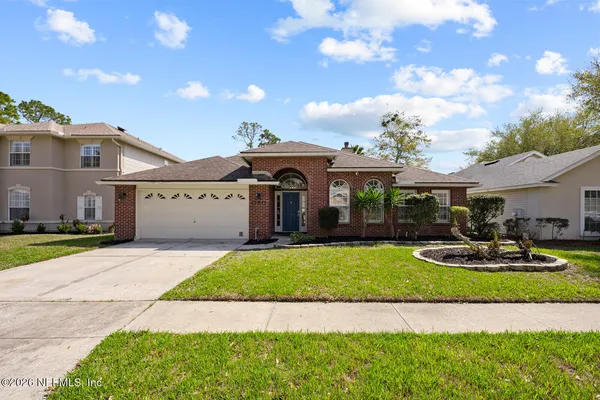 a front view of a house with a yard and garage